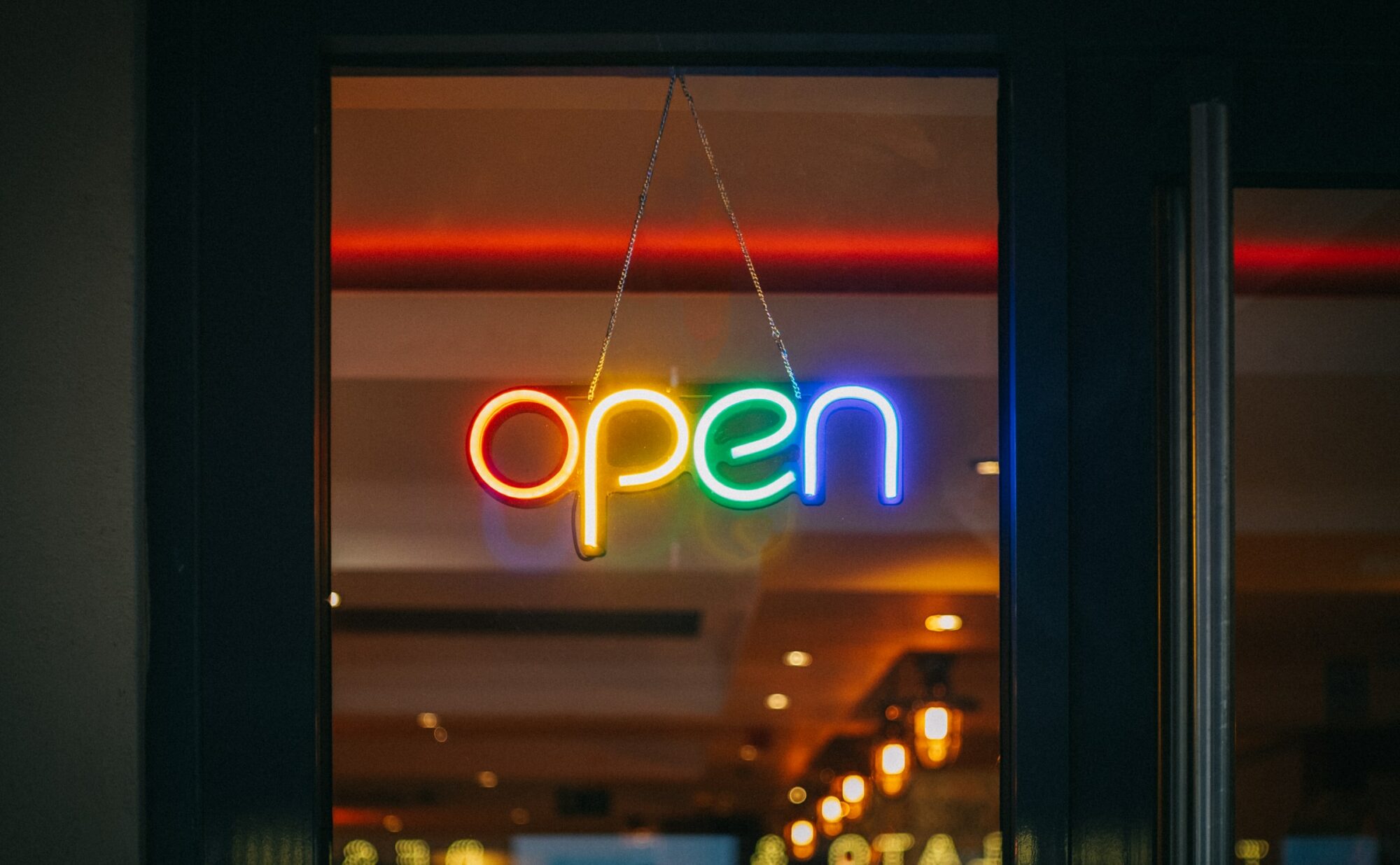rainbow colored neon open sign
